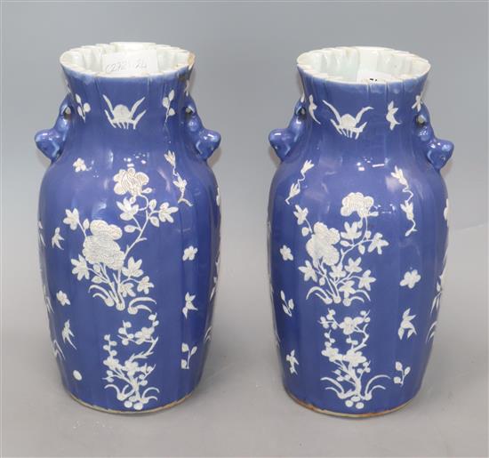 A pair of 19th century Chinese blue ground vases, with white floral decoration